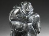 an image of a statue of a man sitting on top of a rock
