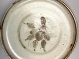 a white plate with a picture of a flower on it