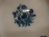 a close up of a plate with blue flowers on it
