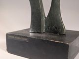 statue of a woman ' s legs on a book with a white background