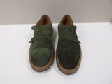 the shoes are green and brown on a white surface