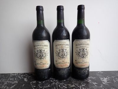 three bottles of wine sitting on top of a table next to each other