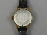a close up of a watch on a white surface