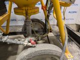 a machine that is sitting on the ground next to a tire