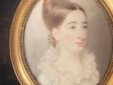 portrait of a woman in a white dress in a gold frame