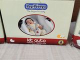 three boxes of baby products sitting on a bed next to each other
