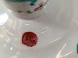 a white plate with a red wax stamp on it
