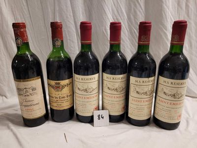 six bottles of red wine are lined up on a table