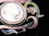 a picture of a brooch with a woman ' s face in it