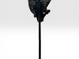 an image of a sculpture of a bird sitting on top of a wooden stand