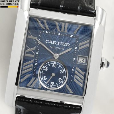 a close up of a watch with roman numerals on the face