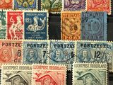 several different colored stamps are on display in a glass case