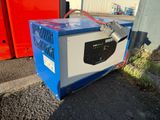 a blue and white box sitting on the side of the road