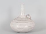 a white vase that is sitting on a table