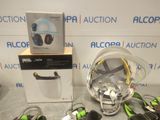 a box with a helmet, headphones, and other items on it
