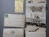 several old postcards and envelopes are on a table