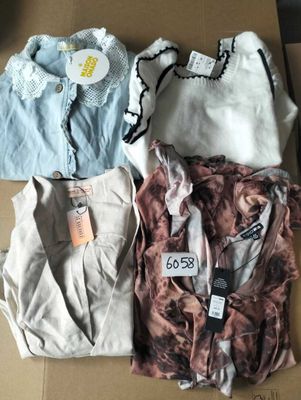 three shirts are sitting on a cardboard box with tags on them