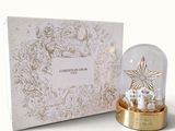 a snow globe with a snowman in it next to a box