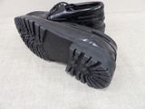 pair of black leather shoes with black soles on a white surface
