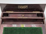 a wooden box with a green mat inside of it