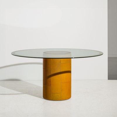 an image of a glass table with a wooden base and a round glass top