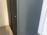 a metal cabinet in the corner of a room