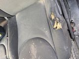 an image of a dirty car seat with a flower on it