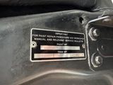 a close up of a metal plate on the back of a motorcycle