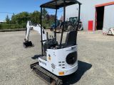 an image of a small excavator parked in a lot