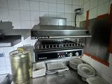 une cuisine équipée d'une cuisinière, d'un four et d'assiettes posées sur le plan de travail