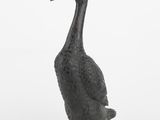 a statue of a duck that is standing in the snow