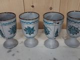 four blue and white vases sitting on top of a marble counter top