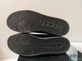 the soles of a pair of adidas shoes are stacked on top of each other