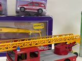 a toy firetruck and a toy car on a table