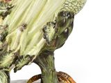 a figurine of a bird on a plate