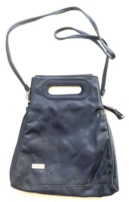 black leather purse with handle and strap on a white background