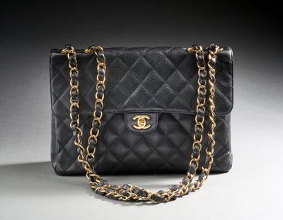 a black chanel bag with a gold chain strap
