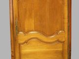 an image of a wooden cabinet with a door on top of it