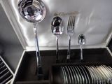 a box with silverware in it and a silver spoon and fork in it