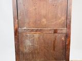 an old wooden cabinet sitting on top of a hard wood floor