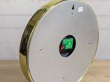 a clock that is sitting on a wooden table