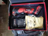 a box with a cordless drill and other tools in it