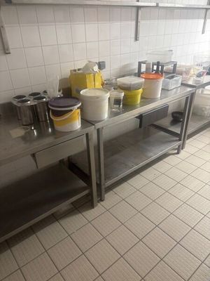many pots and pans sitting on a stainless steel table