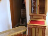 a wooden cabinet and a bench in a living room