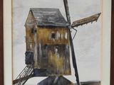 painting of a windmill in a frame on a wall
