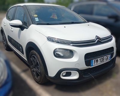 a picture of a white citrole parked in a parking lot
