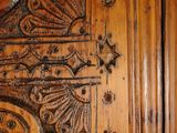 a close up of a wooden door with intricate carvings