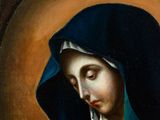 a painting of a woman in a blue robe holding a rosary
