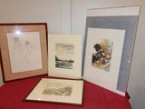 three framed pictures on a table with a red table cloth