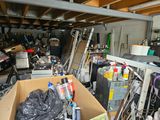 a box full of stuff in a garage with a lot of clutter on the floor